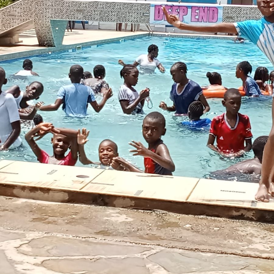 Learners splashing and jumping into the pool on swimming day